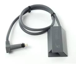 A Starlink Ethernet adapter with a grey body and a black cable, designed for connecting to the Starlink routers.